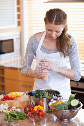 Woman peppering her meal