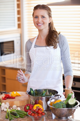 Smiling woman preparing the dinner