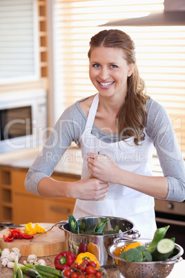 Woman adding pepper to her meal