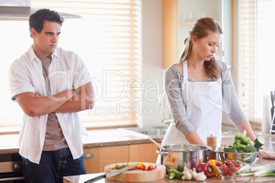 Man watches his girlfriend cooking