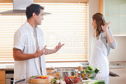 Couple has a tensed situation in the kitchen