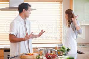 Couple has a tensed situation in the kitchen