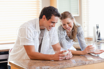 Couple having a glass of milk in the kitchen