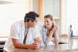 Couple in the kitchen looking at each other