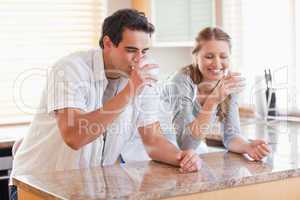 Couple drinking milk in the kitchen