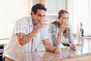 Couple enjoying some milk in the kitchen