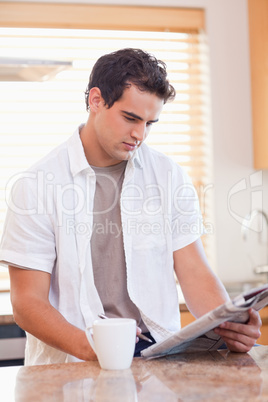 Man doing crossword puzzle in the kitchen