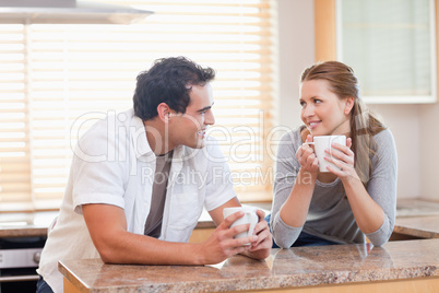 Couple enjoying coffee in the kitchen together