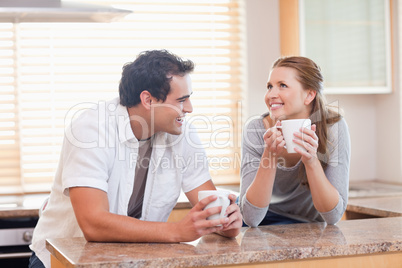 Cheerful couple having coffee together