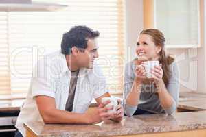 Cheerful couple having coffee together