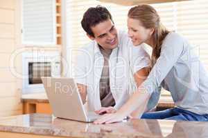 Couple with laptop in the kitchen