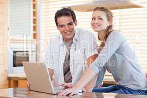 Couple with notebook in the kitchen