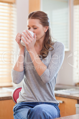 Woman relaxing with coffee in the kitchen