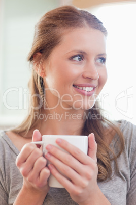 Close up of smiling woman with a cup of tea