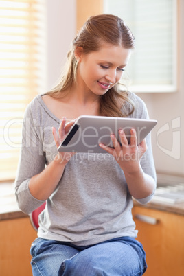 Woman with tablet in the kitchen