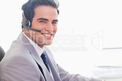 Side view of smiling businessman with headset on