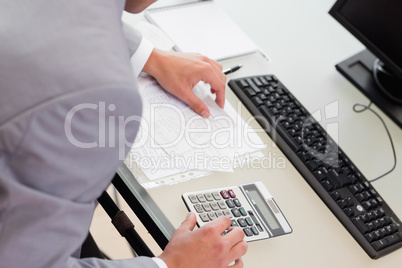 Above view of businessman using table calculator