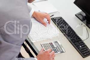 Above view of businessman using table calculator