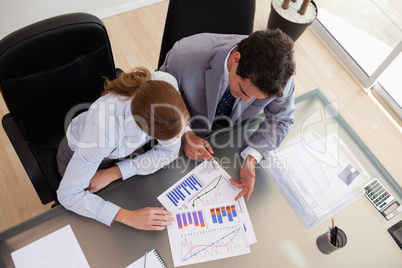 Above view of consultant analyzing data with her client