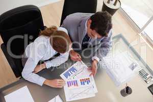 Above view of consultant analyzing data with her client