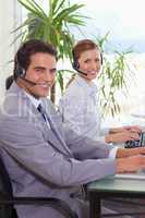 Side view of smiling call center agents
