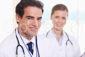 Smiling medical assistants standing next to each other