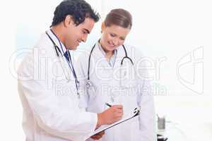 Young medical staff working on patient record