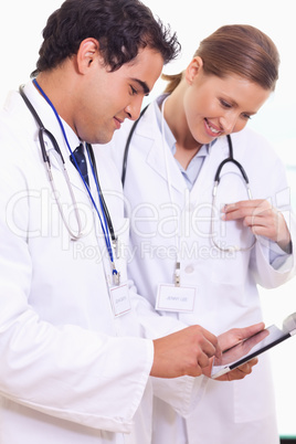 Young assistant doctors using tablet