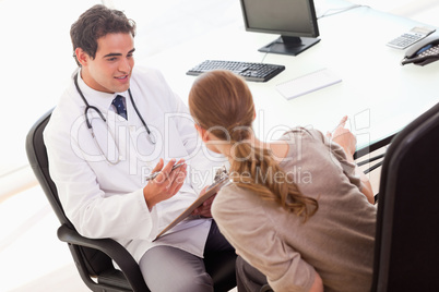 Doctor asking his patient for symptoms