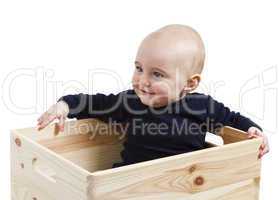 toddler in wooden box