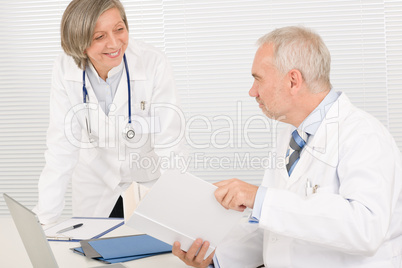 Medical team senior doctor with work colleague