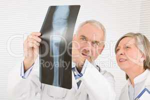 Medical team senior doctors look at x-ray