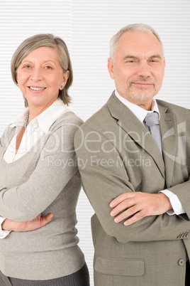 Senior businesspeople smile cross arms portrait