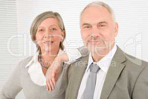 Senior businesspeople lean over shoulder colleague