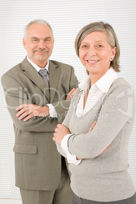 Senior businesspeople smile cross arms portrait