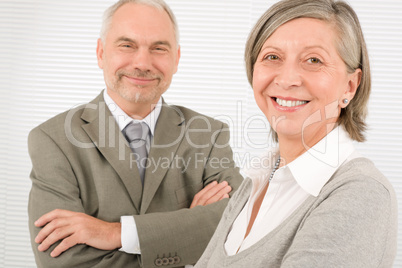 Senior businesspeople smile cross arms portrait
