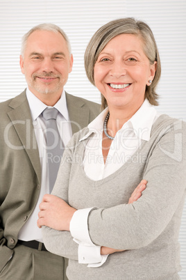 Senior businesspeople smile cross arms portrait