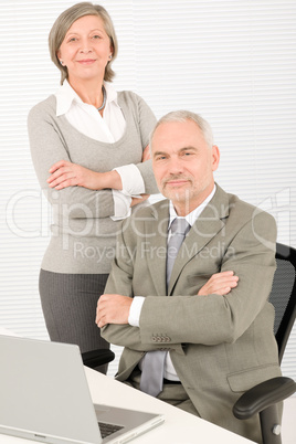 Senior businesspeople behind office table computer