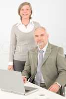 Senior businesspeople behind office table computer