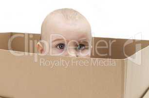 young child in cardboard box