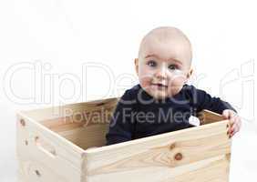 toddler in wooden box