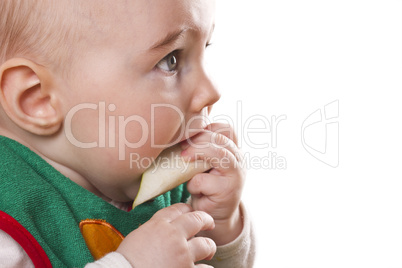 baby sitting and eating an apple