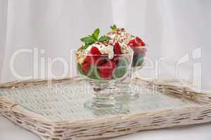 Strawberries with biscuit pieces with mint whipped cream under