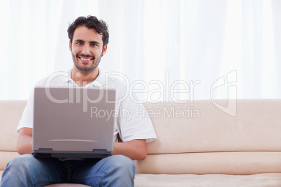 Smiling man using a laptop Smiling man using a laptop