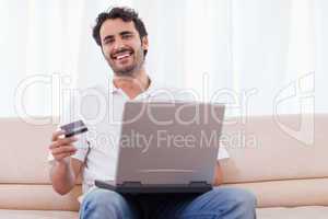 Smiling man buying online
