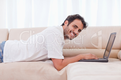 Smiling man using a notebook Smiling man using a notebook