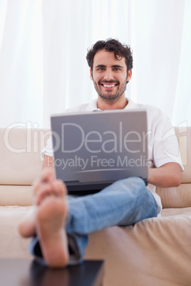 Portrait of a young man using a notebook