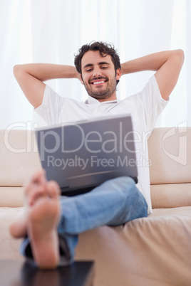 Portrait of a happy man using a laptop