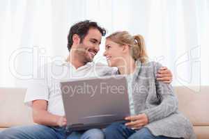 Happy couple using a laptop