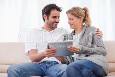 Young couple using a tablet computer